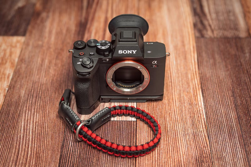 The Sony A7RV with SmallRig baseplate, Hoodman eyecup, and a paracord wrist cuff.