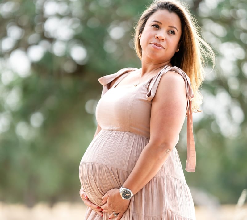 Maternity portrait against greenery